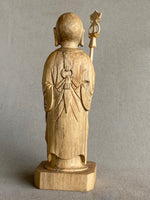 Load image into Gallery viewer, Light colored handcarved wood statue of Jizo as a man, holding a staff with 6 gold rings and in his other hand the Wish Fulfilling Gem, back view
