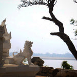 Load image into Gallery viewer, Chinthe Burmese Lion Guardian in front of temple in Burma next to the river. 
