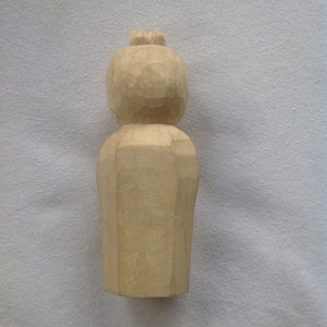 Back view, simple detail, only marks of the tools ,5 inch tall light colored wood hand carved statue of a Japanese Kuan Yin, knows as Kannon, holding a lotus.