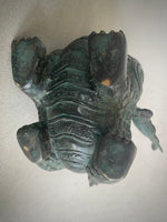 Load image into Gallery viewer, A dark green patinated bronze dragon figurine showing the underside against a plain off-white background.
