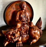 Load image into Gallery viewer, Woodcarving Manjushri as a young monk tranquilly seated in meditation on a lion with red lacquer tray behind
