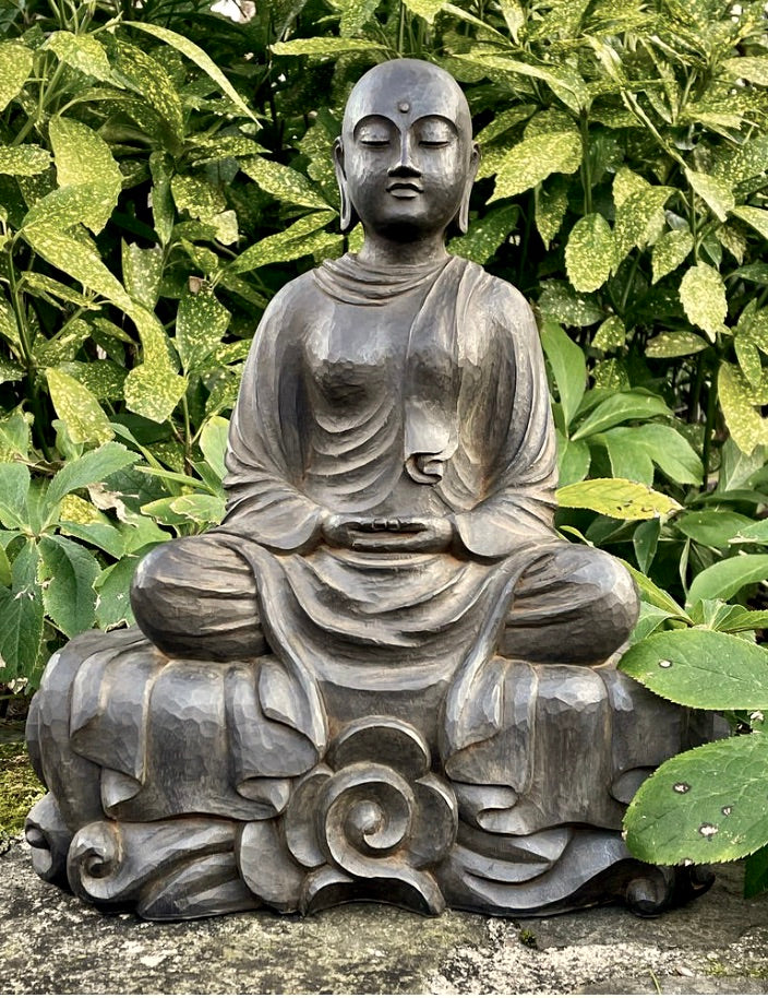 Patacara, a serene Buddhist Nun seated in a garden in meditation on an abstract flower base, with her robes flowing over it.
