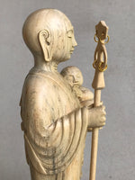Load image into Gallery viewer, JIzo man standing, holding a staff and a baby, 25cm, 10 inches, color variation in wood from warm light brown to grey grain, close up view of right side.
