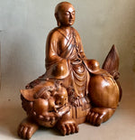 Load image into Gallery viewer, Woodcarving Manjushri as a young monk tranquilly seated in meditation on a lion.
