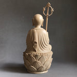 Load image into Gallery viewer, Hand carved light wood statue of Jizo Bodhisattva seated on a lotus staff in one hand and wish fulfilling gem in the other back view
