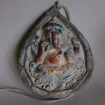 Load image into Gallery viewer, A ceramic pendant featuring an image of Ganesha, predominantly gray in color with red and gold accents, suspended by a string.
