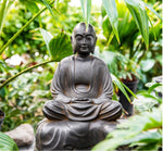 Load image into Gallery viewer, Jizo in Meditation serenely seated on a rock in a garden warm rust brown
