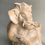 Load image into Gallery viewer, Genesha statue seated with lontar. 5 inches tall, hand carved from light colored wood. closeup
