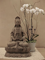 Load image into Gallery viewer, Quan Yin Statue Seated on Double Lotus original on altar at Spirit Rock Meditation Center with white orchids behind.
