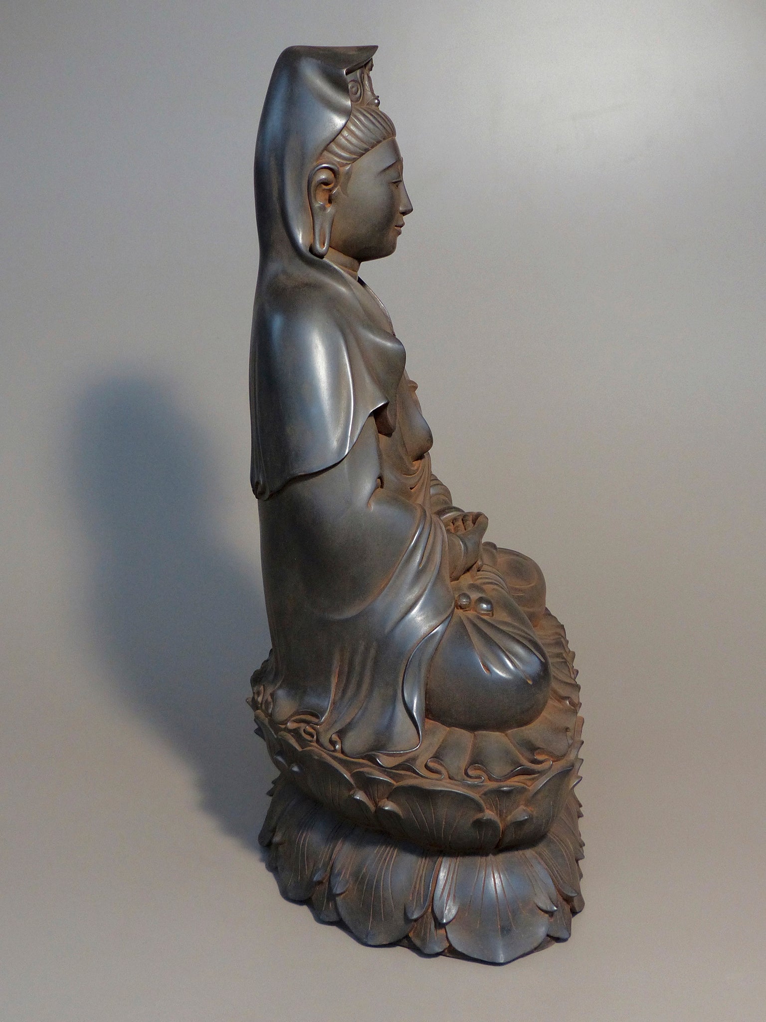 Quan Yin statue seated antique rust 24 inches side view