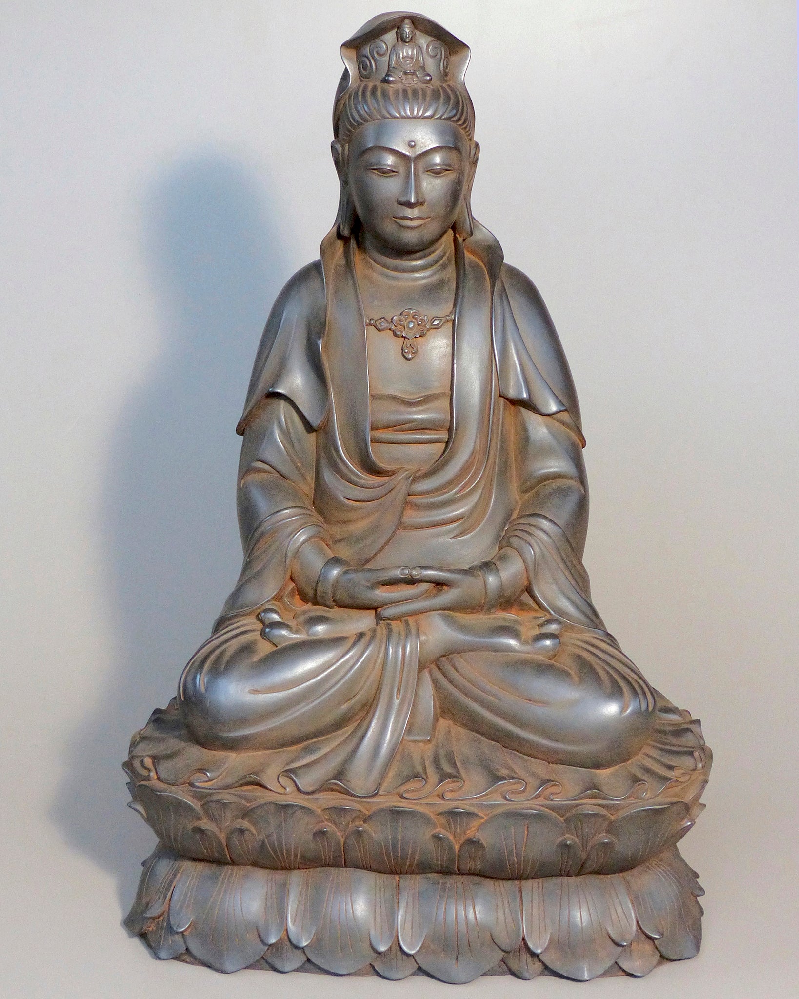 Quan Yin statue seated in Meditation. A small Buddha in her headdress and a serene feeling. Antique rust color 24 inches