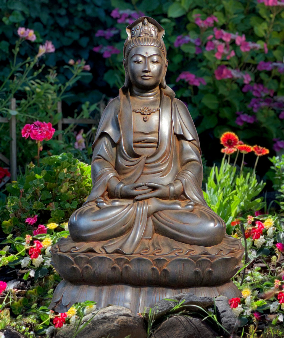 Quan Yin statue seated on double lotus in a garden of flowers.A small Buddha in her headdress and a serene feeling. Antique rust color 24 inches